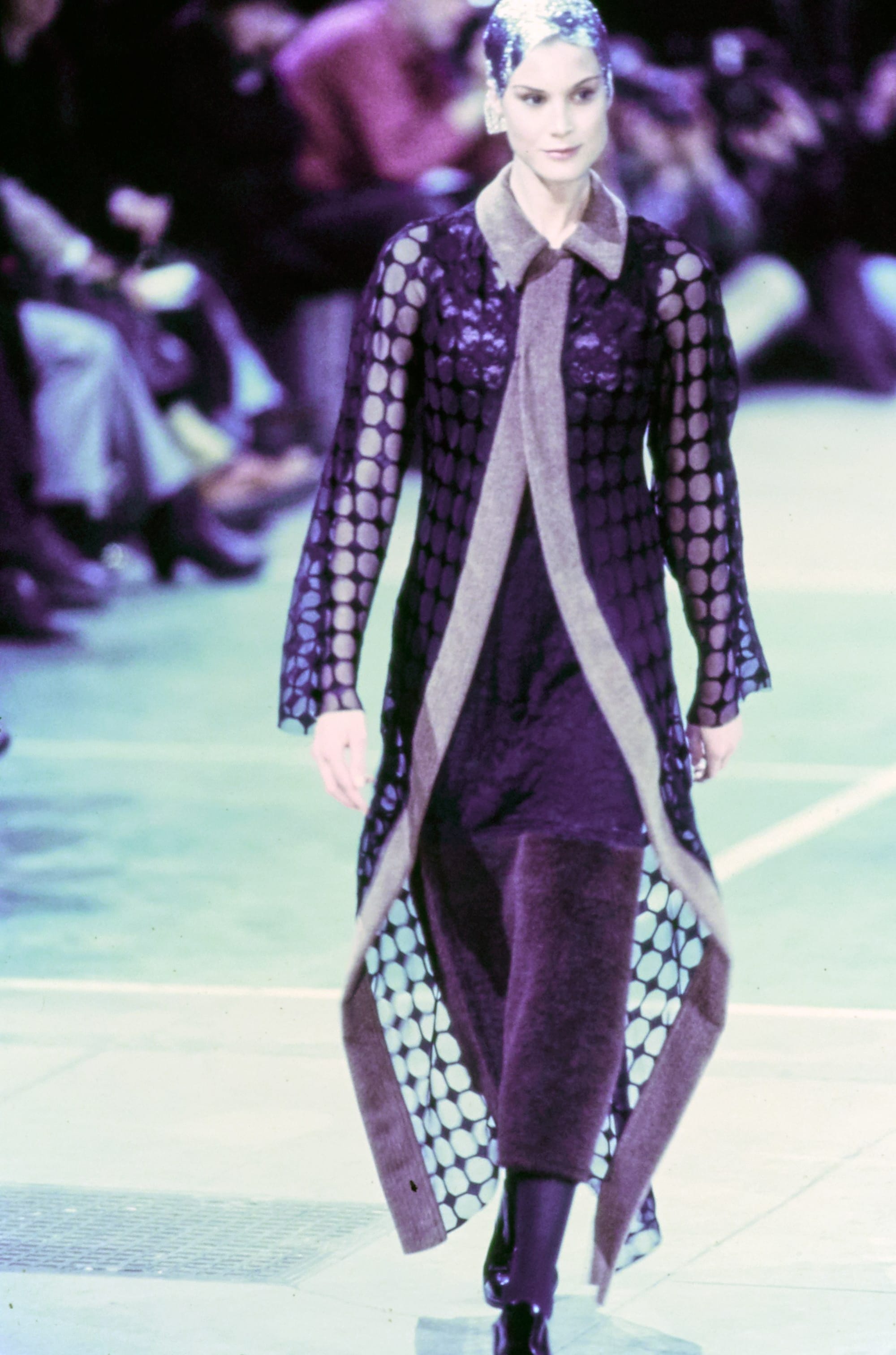 Comme des Garçons Fall 1993 Ready-to-Wear runway look 71: long patterned coat over black and purple layers.