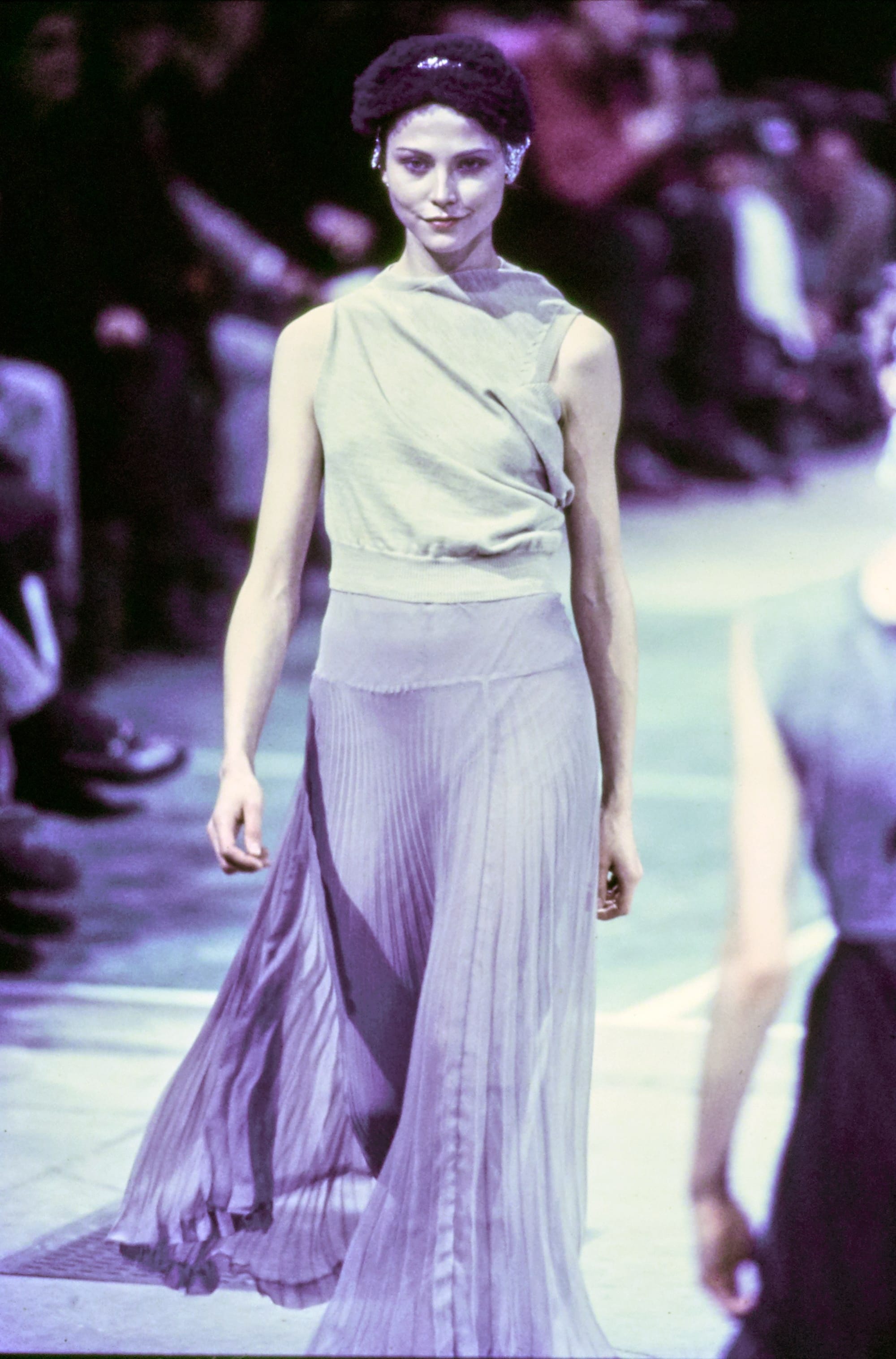 Comme des Garçons Fall 1993 Ready-to-Wear runway look 86: pale green top with a sheer purple skirt and head wrap.