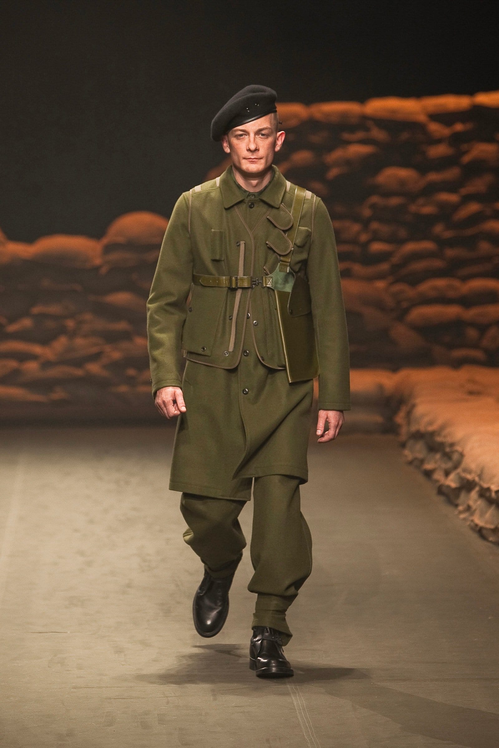 N.Hoolywood Autumn/Winter 2010–11 runway look 3: dark olive belted field jacket with wide military trousers and a black beret.