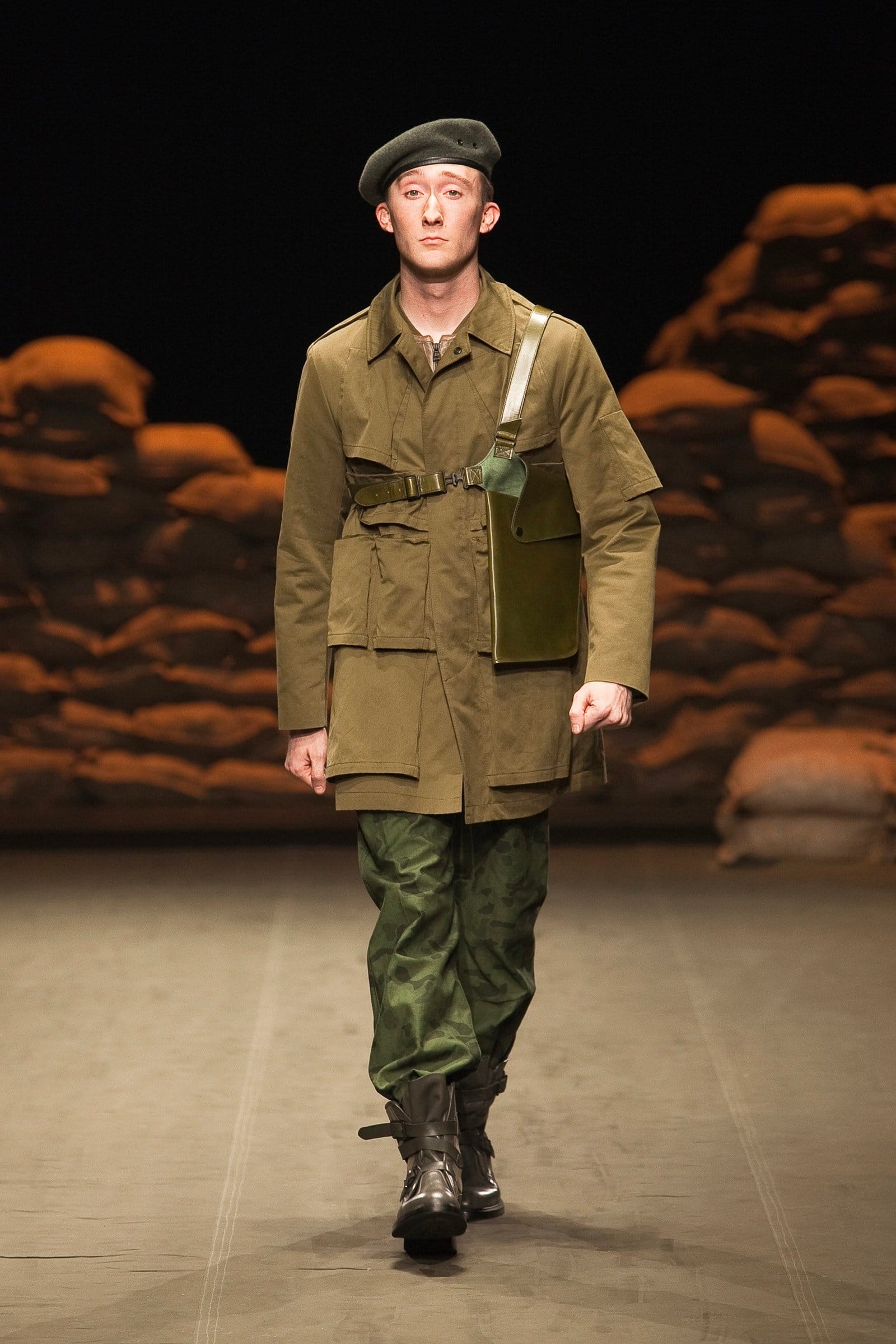 N.Hoolywood Autumn/Winter 2010–11 runway look 27: olive patchwork field jacket over camouflage trousers with black beret.