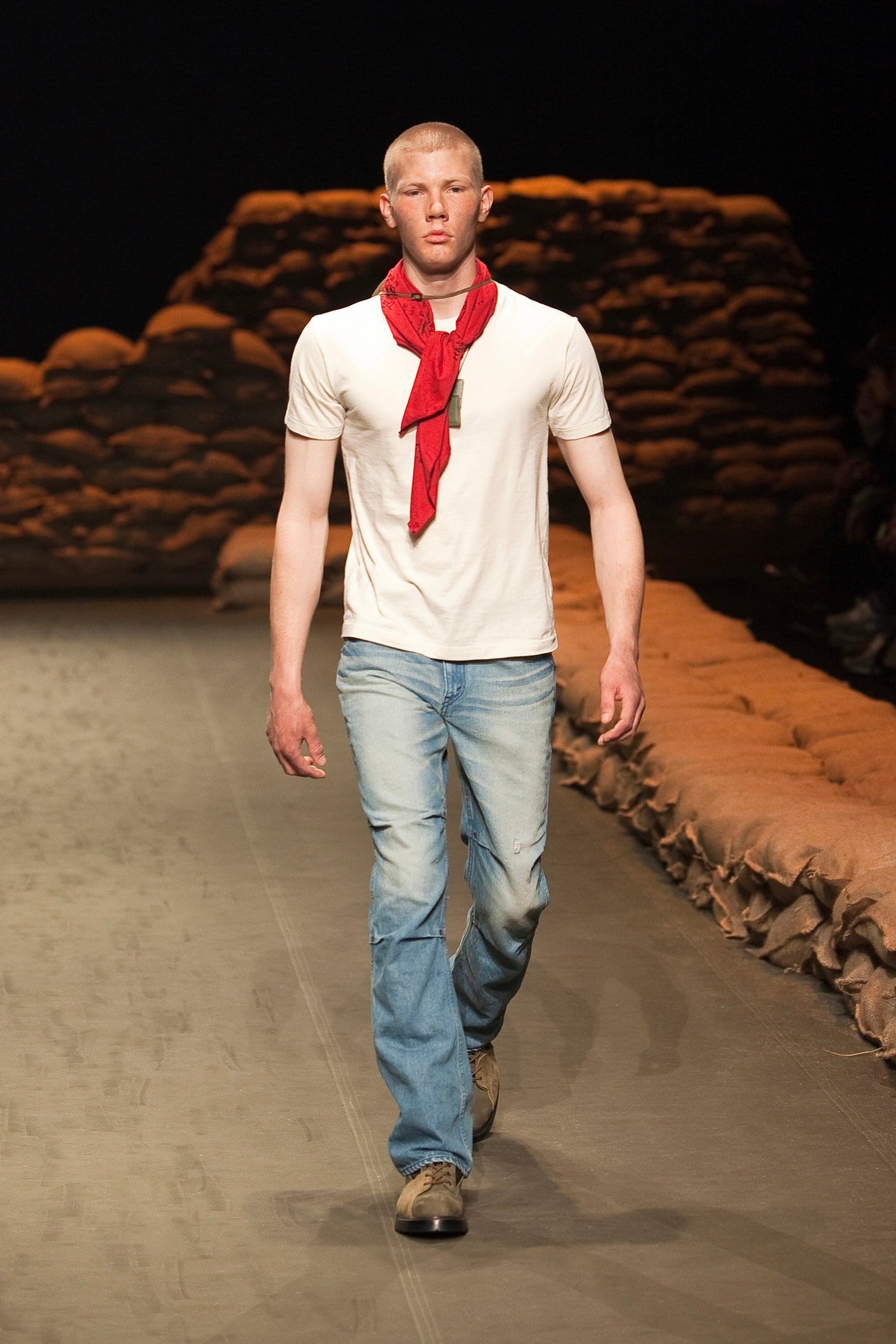 N.Hoolywood Autumn/Winter 2010–11 runway look 40: white T-shirt and faded jeans with a red scarf and combat boots.
