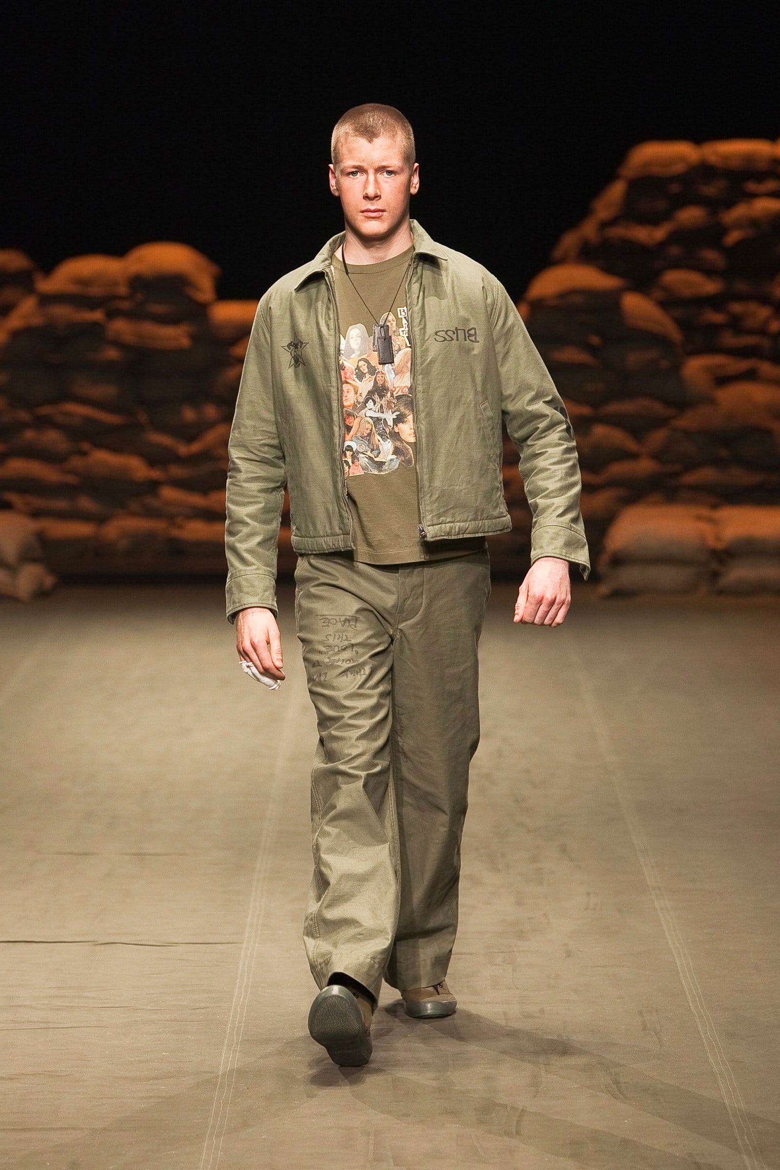 N.Hoolywood Autumn/Winter 2010–11 runway look 41: olive bomber jacket and matching trousers over a printed T-shirt.