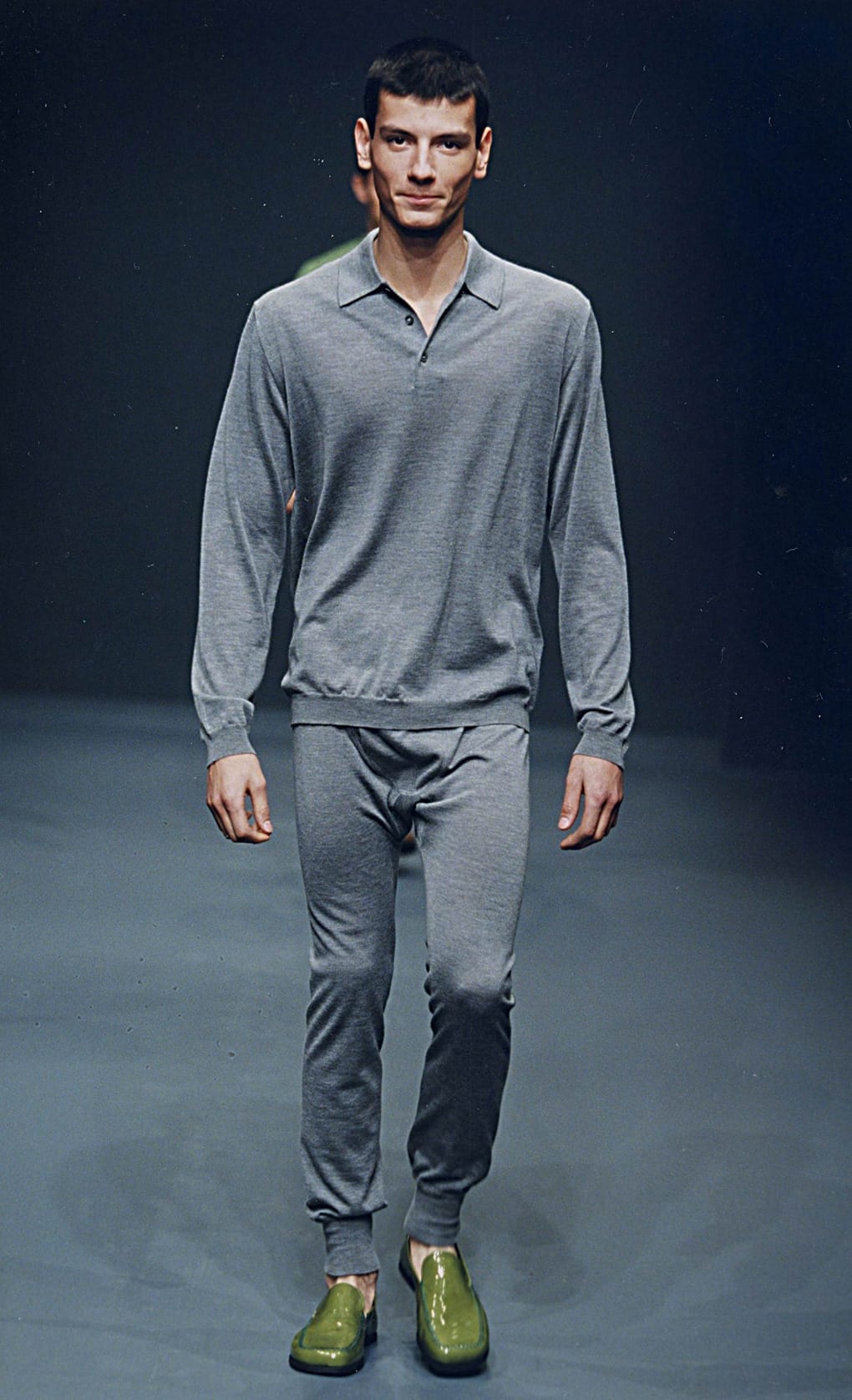 Prada Fall/Winter 1999 menswear runway look 25: grey collared top and matching trousers with bright green shoes.