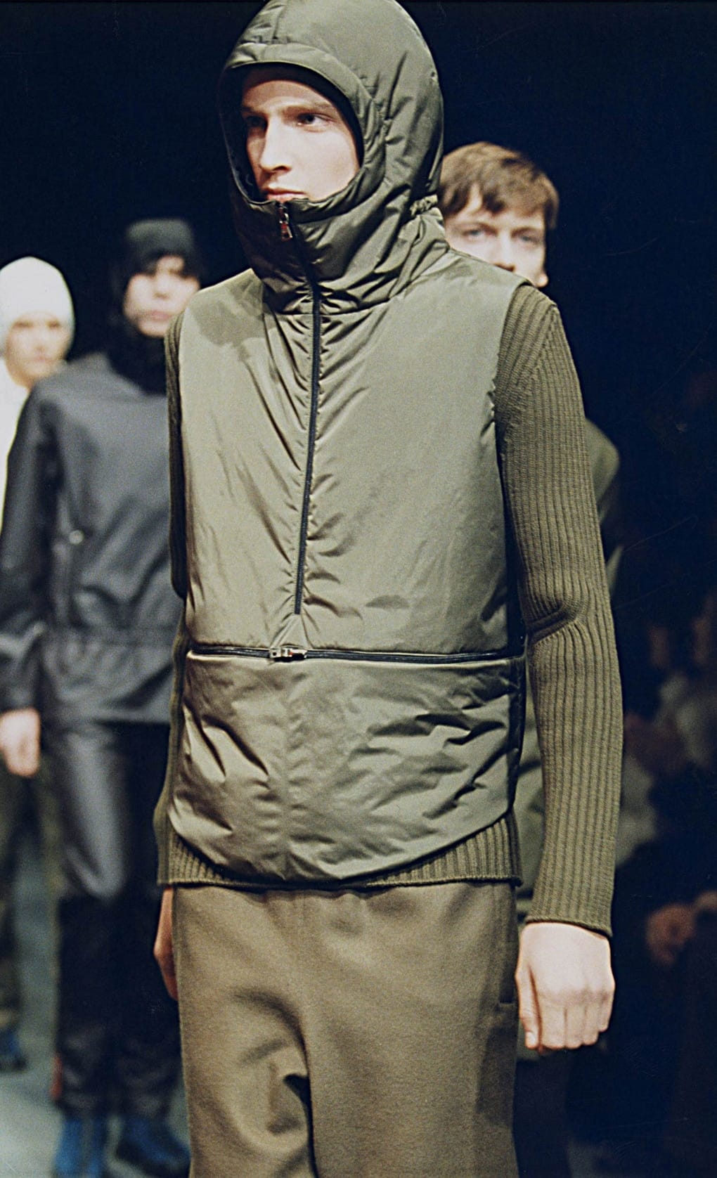 Prada Fall/Winter 1999 menswear runway look 41: olive padded vest over a ribbed sweater with matching trousers.