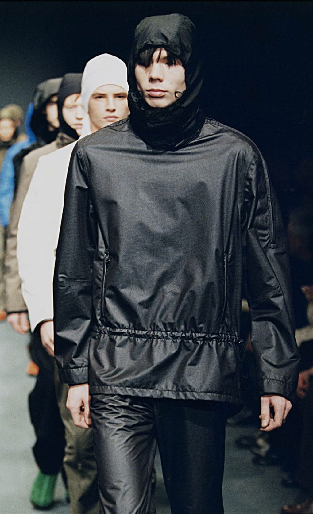 Prada Fall/Winter 1999 menswear runway look 44: black hooded technical pullover with matching trousers.
