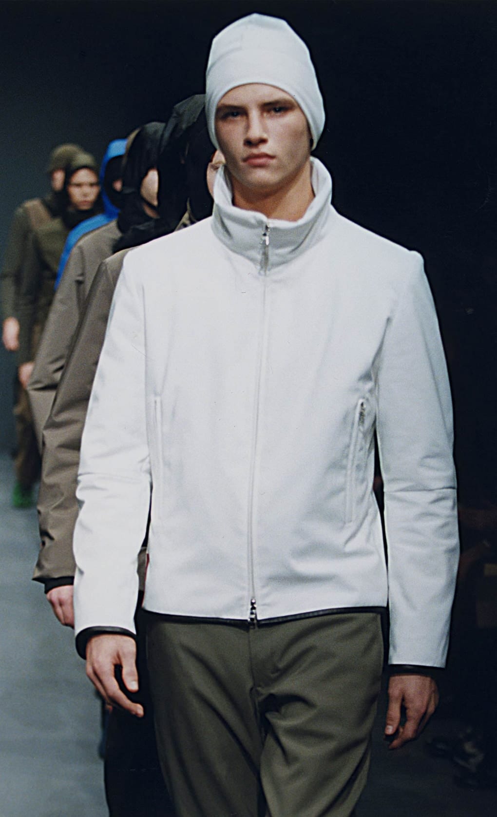 Prada Fall/Winter 1999 menswear runway look 45: white technical jacket with olive trousers and white hood.