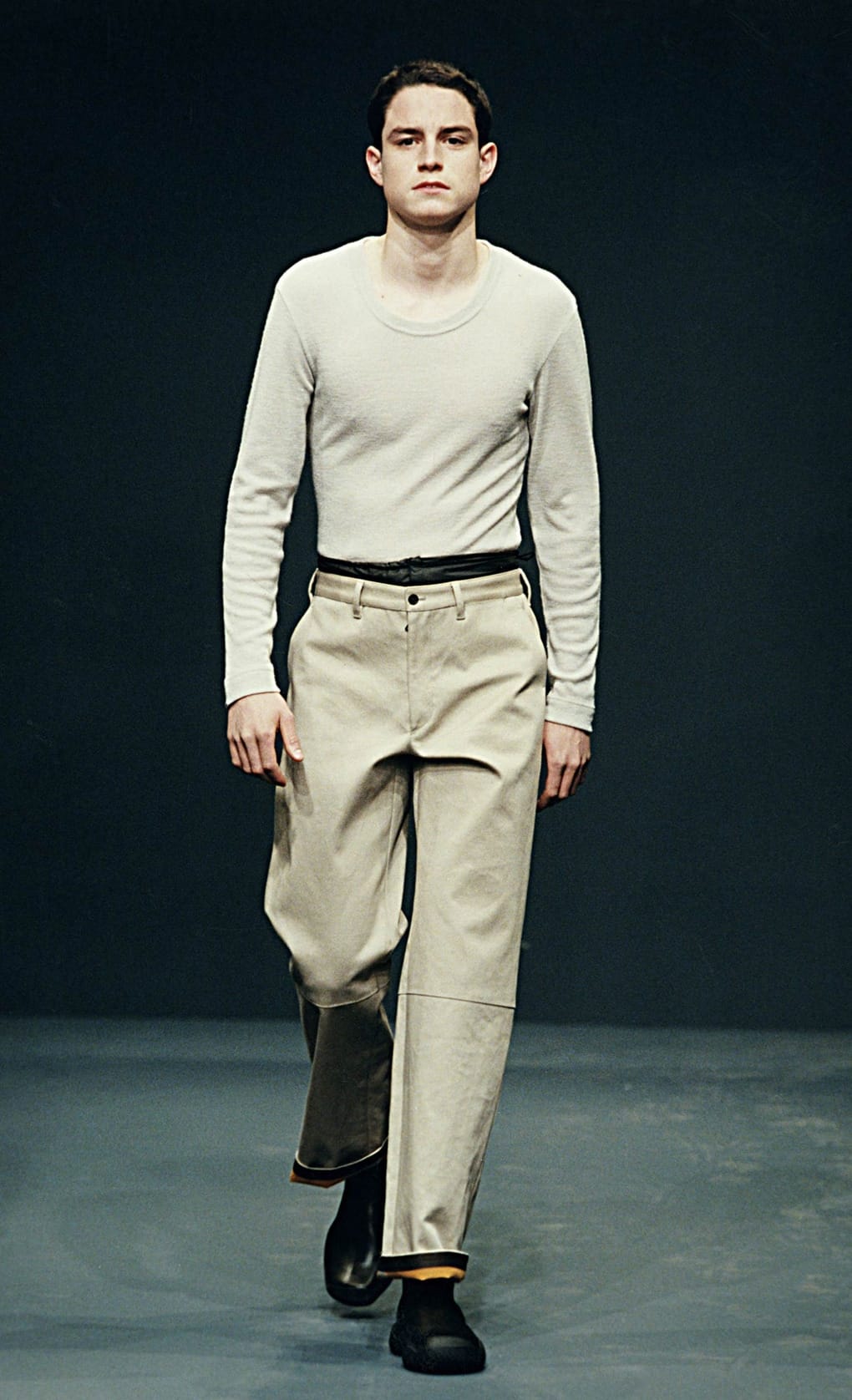 Prada Fall/Winter 1999 menswear runway look 57: cream long-sleeve top tucked into pale cropped trousers.
