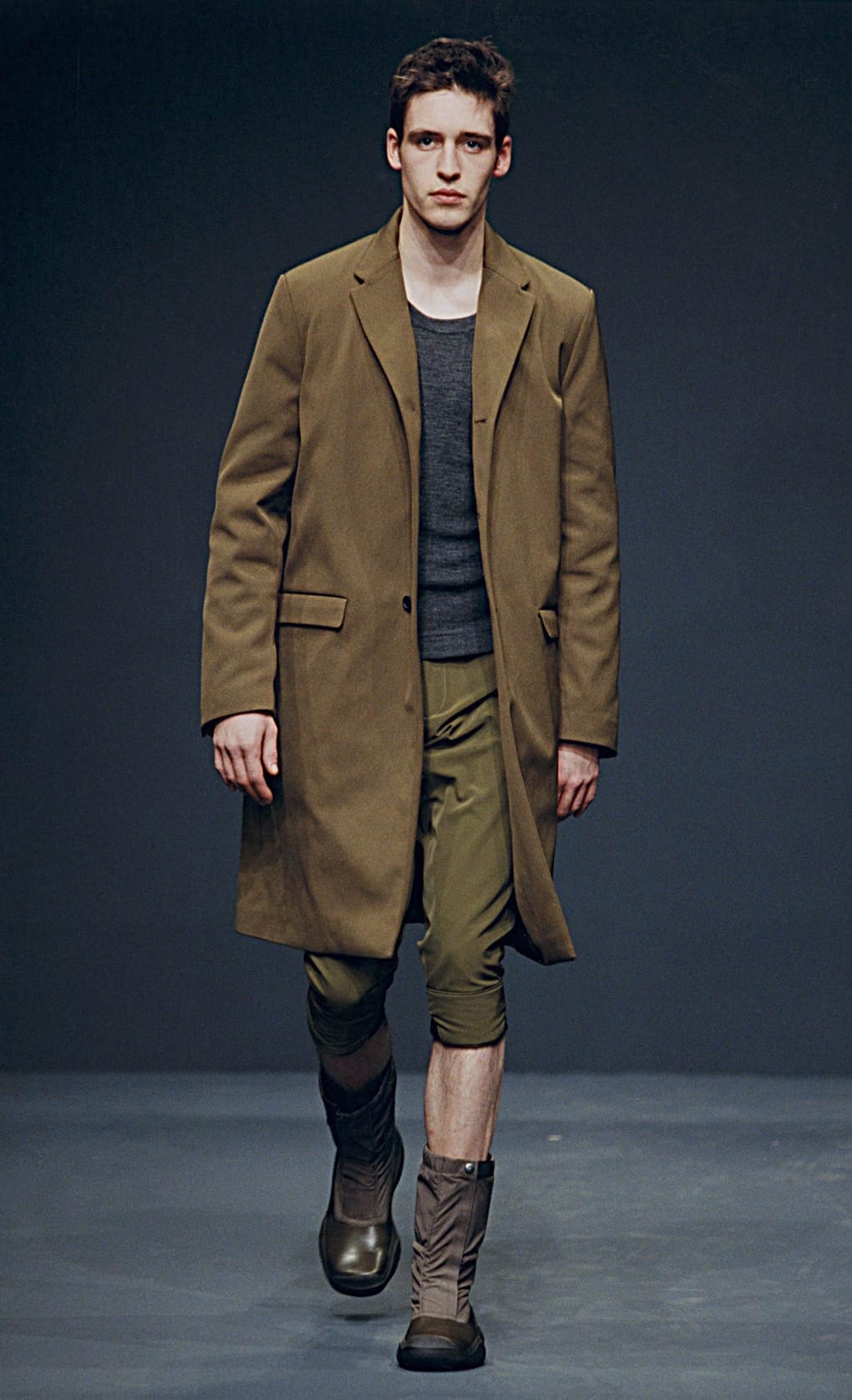 Prada Fall/Winter 1999 menswear runway look 69: olive long blazer over green cropped trousers and boots.