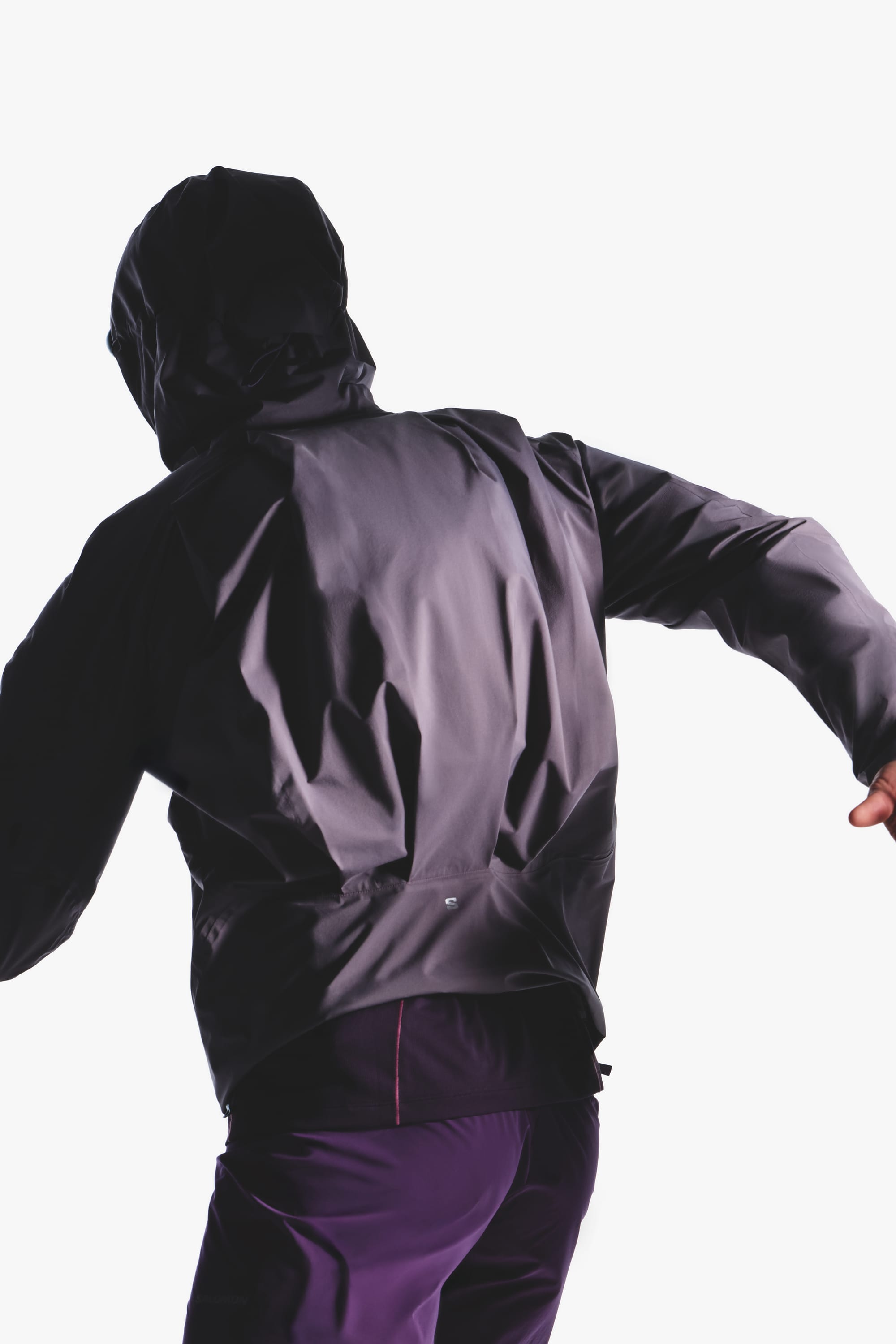 Rear view of the Salomon men's Autumn/Winter 2026 purple hooded trail-running jacket.