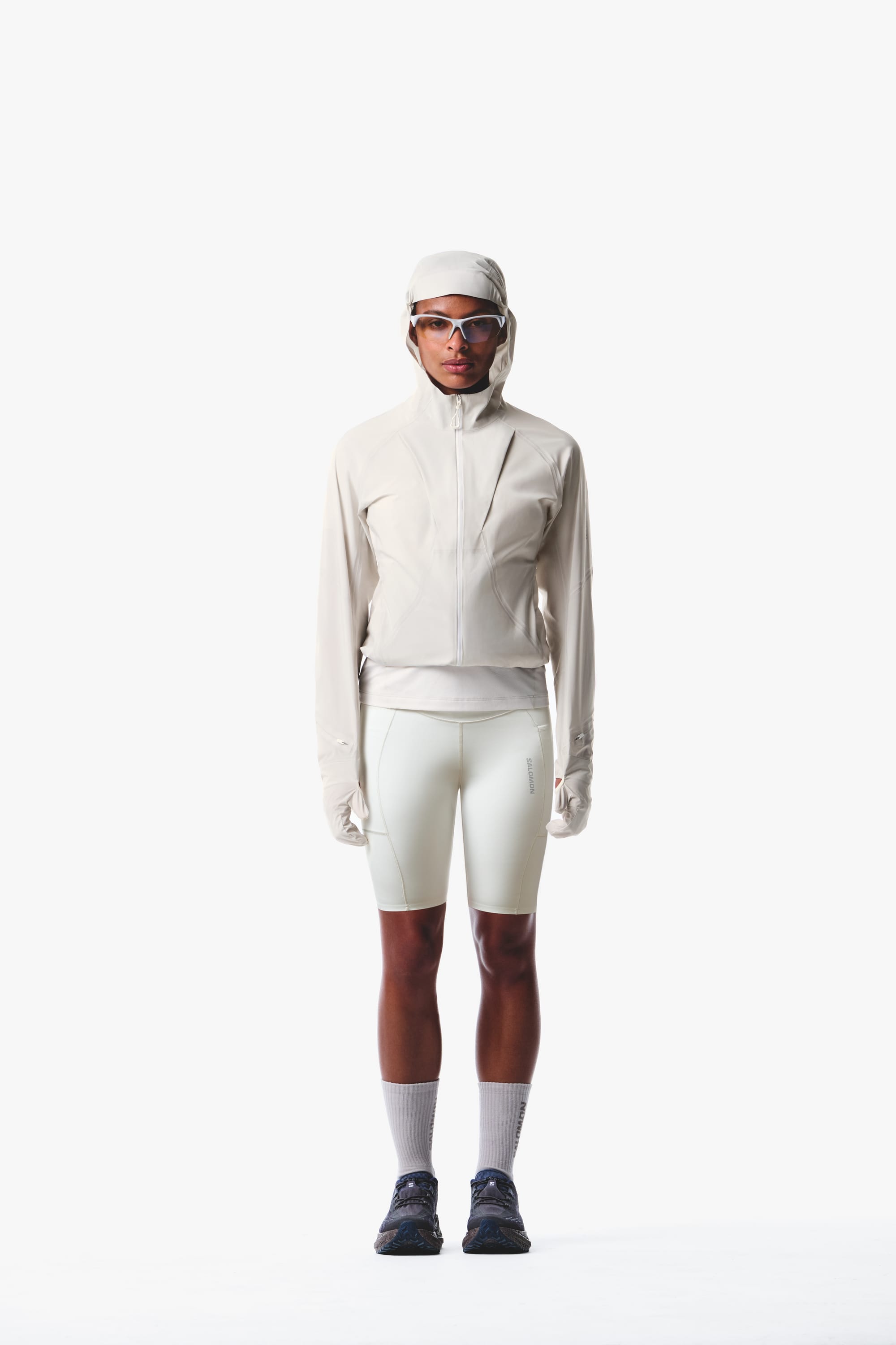 Salomon women's Autumn/Winter 2026 collection portrait with one man and two women in purple and white technical running kits.