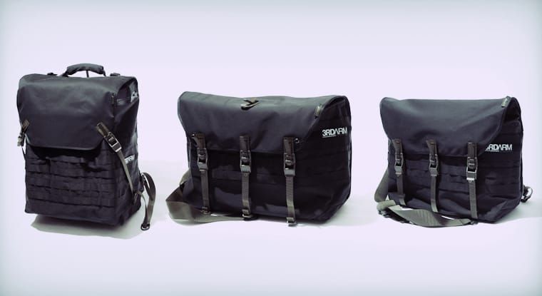 Set of black technical bags and packs on a studio background.