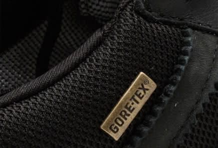 Close detail of a Gore-Tex label on black textured fabric.