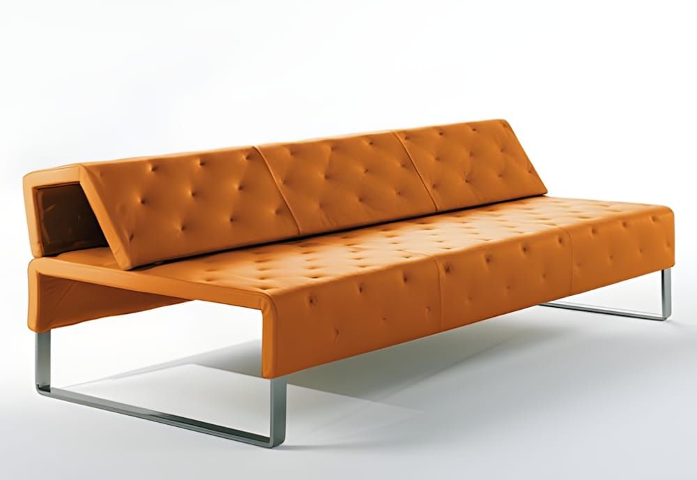 Matteograssi Jazz sofa in tufted cognac orange leather on brushed stainless steel sled legs.