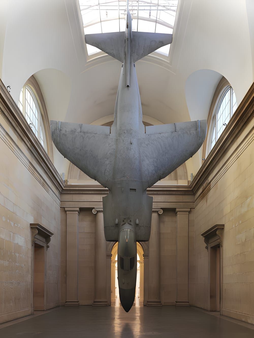Fiona Banner's Sea Harrier jet suspended upside-down, nose pointing down, inside Tate Britain's Duveen Galleries, 2010.