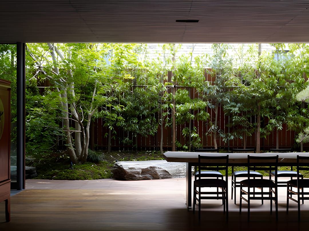 House S by Keiji Ashizawa Design — concrete facade with bamboo flanking the entrance of a single-family residence in a centra