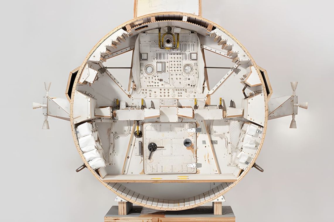 Tom Sachs spacecraft capsule sculpture seen from the front as a circular cross-section, revealing a handbuilt interior with i