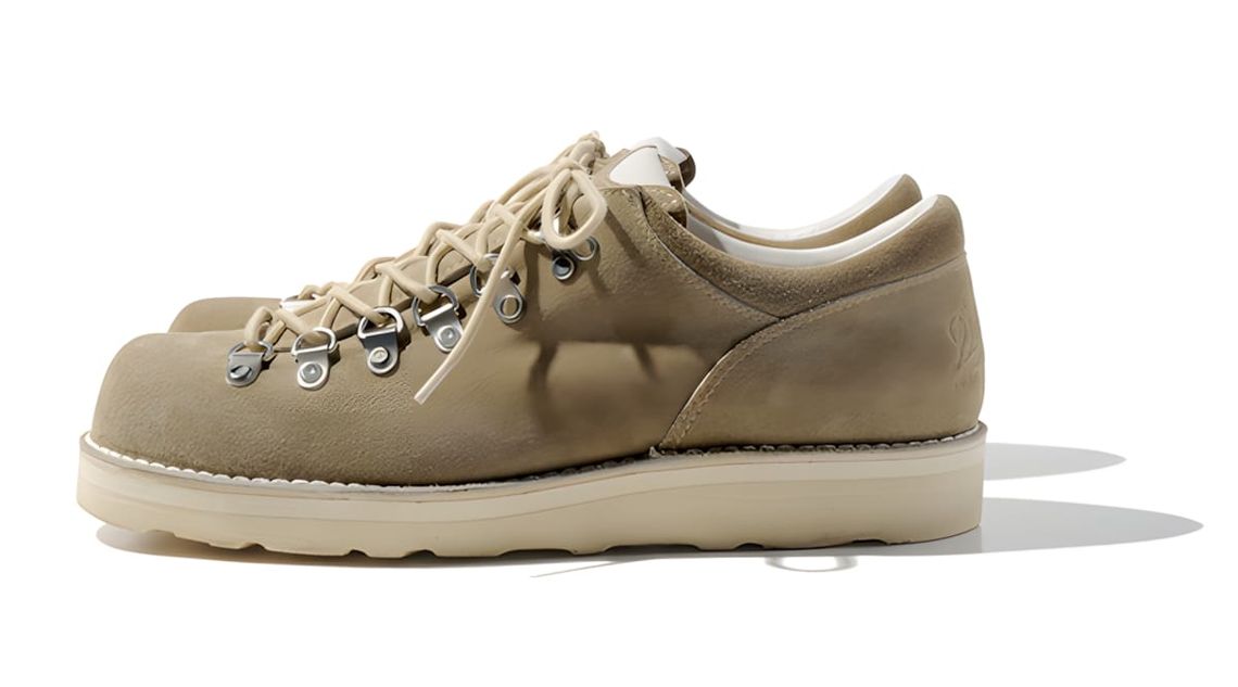 Danner MT. Ridge Low Cristy D-4007 low-top hiking shoe in tan suede, wide landscape shot showing the shoe worn on foot.