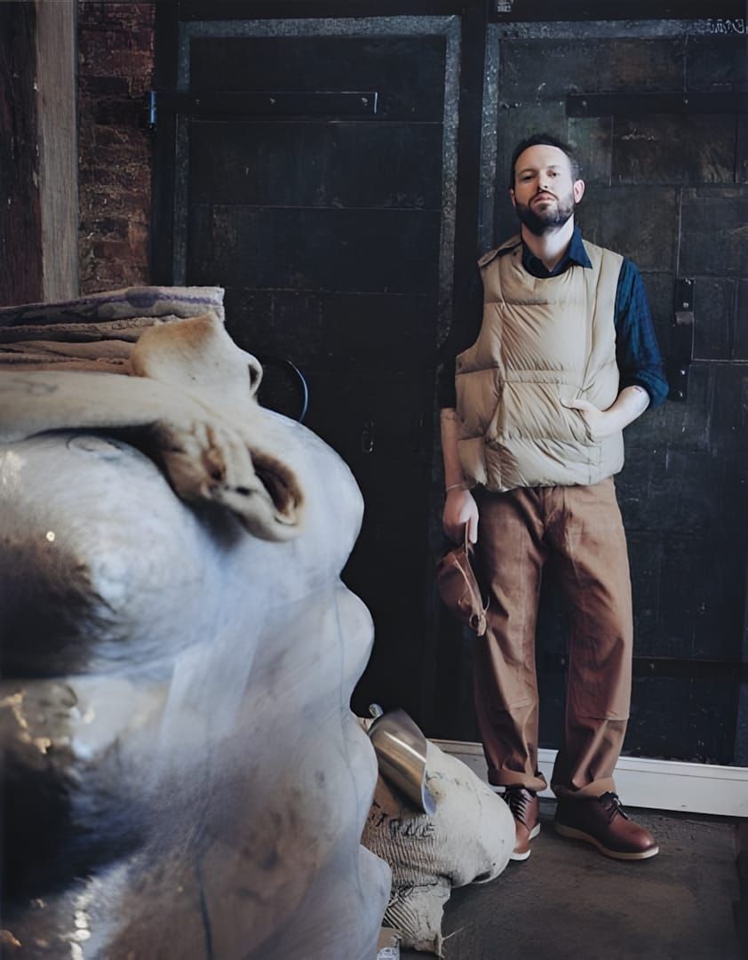 Engineered Garments Down Body Vest in khaki — 100% nylon shell with goose down fill and side-entry velcro and button closure.