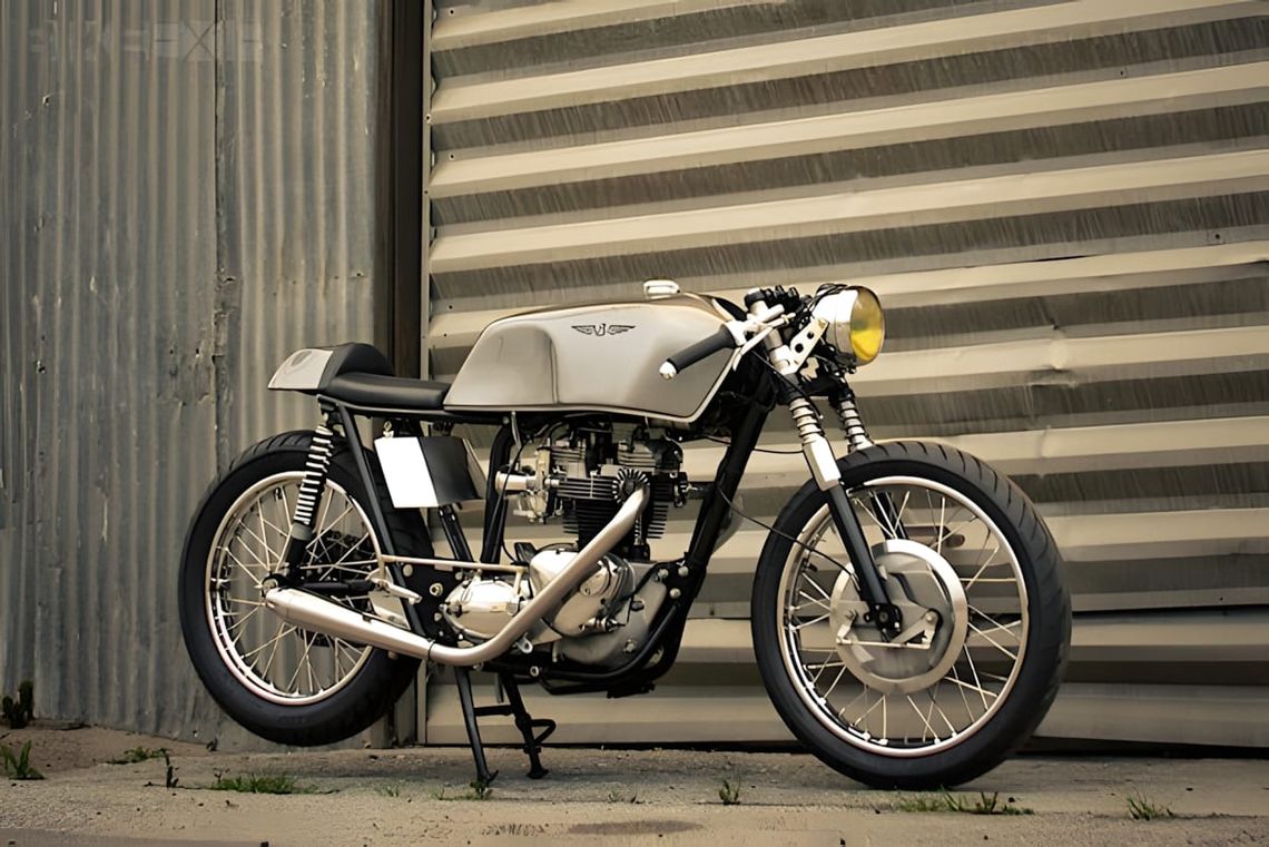 1969 Triumph TR6 Trophy cafe racer by Raccia Motorcycles — bare aluminum tank, black engine, spoked wheels, solo seat hump.