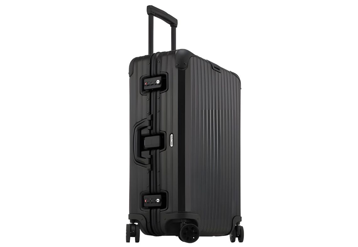 Rimowa Topas Stealth hardshell suitcase in matte black anodized aluminum, shown in three-quarter view with telescoping handle