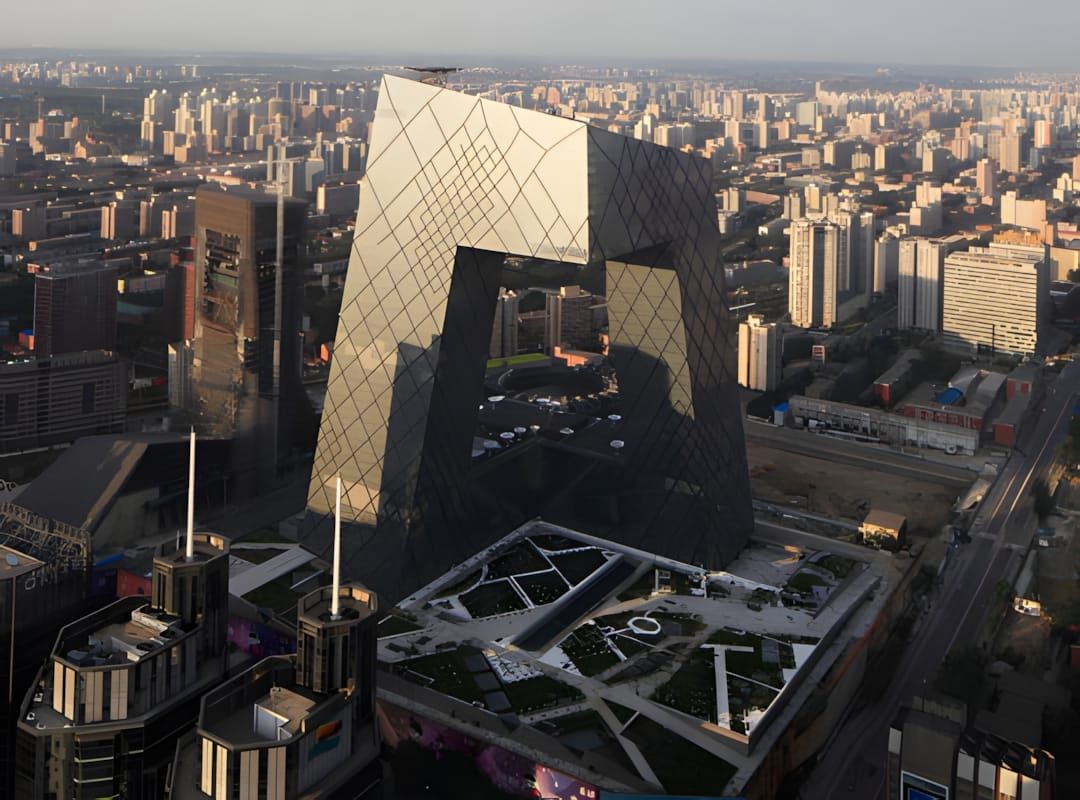 Aerial view of the CCTV Headquarters Beijing — OMA's double-loop steel-and-glass tower rising above the CBD.