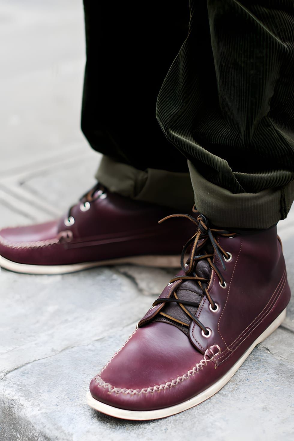 Worn-on-feet shot of Quoddy burgundy oxblood leather chukka boots with moccasin-construction stitching along the toe box, bro