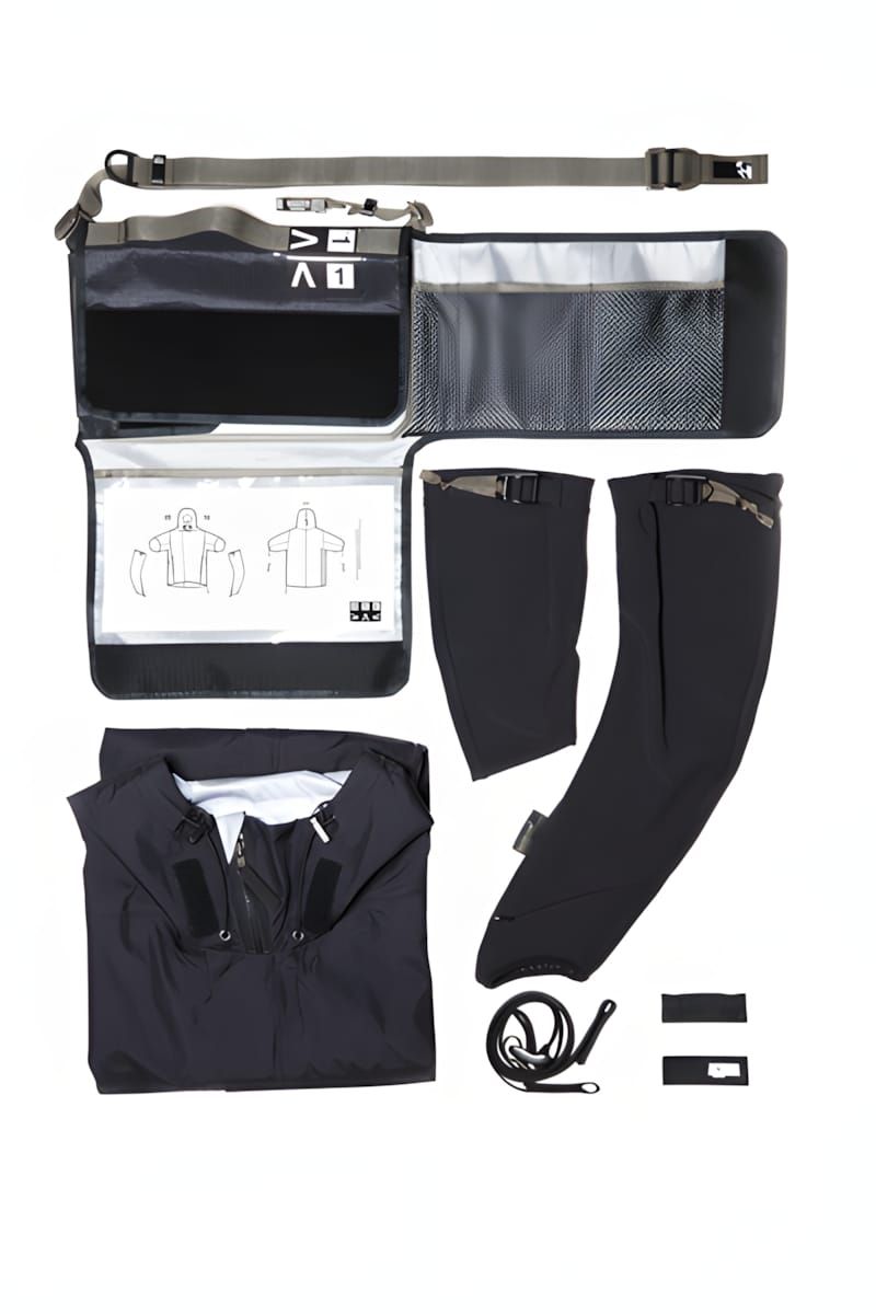 Knolling flat-lay on white showing all components of the Arc'teryx Veilance Field IS jacket: folded black Gore-Tex shell jack
