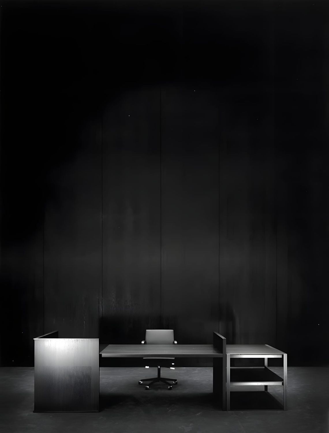 Studio photograph of the Vincent Van Duysen VVD desk system for Bulo in dark-stained finish: central writing desk with swivel