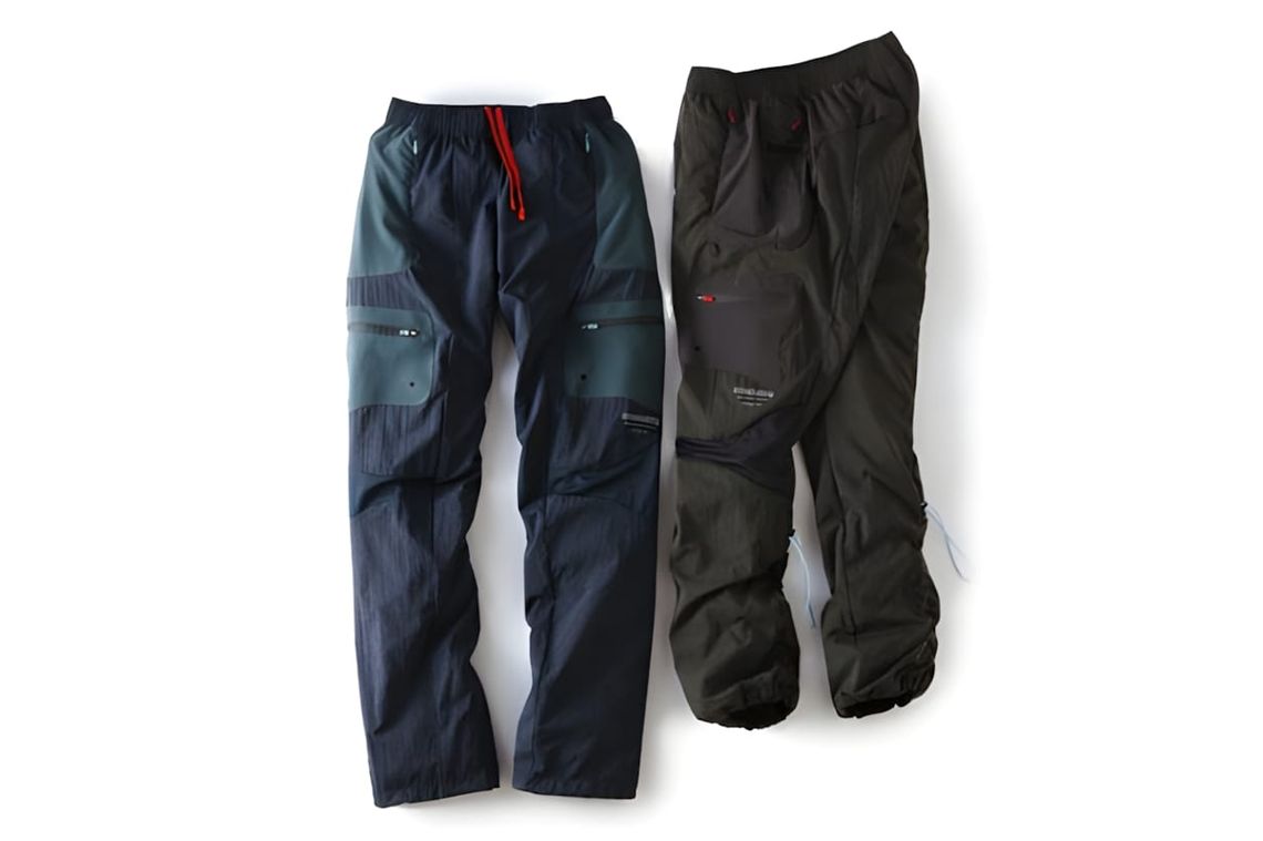Nike x Undercover Gyakusou Fabric Mixed Long Pants SS2012 — navy/teal (left) and black (right) colorways, flat lay.