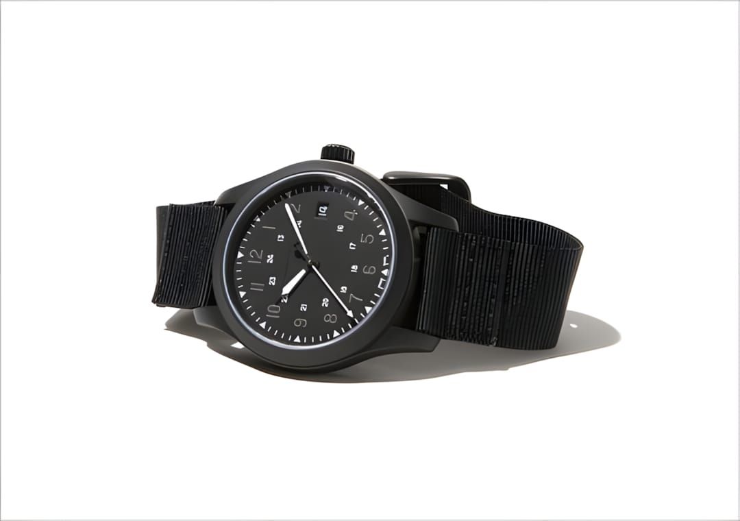 Hamilton Khaki Field Mechanical watch in black PVD-coated case on a black NATO nylon strap, shot on white background. Black d