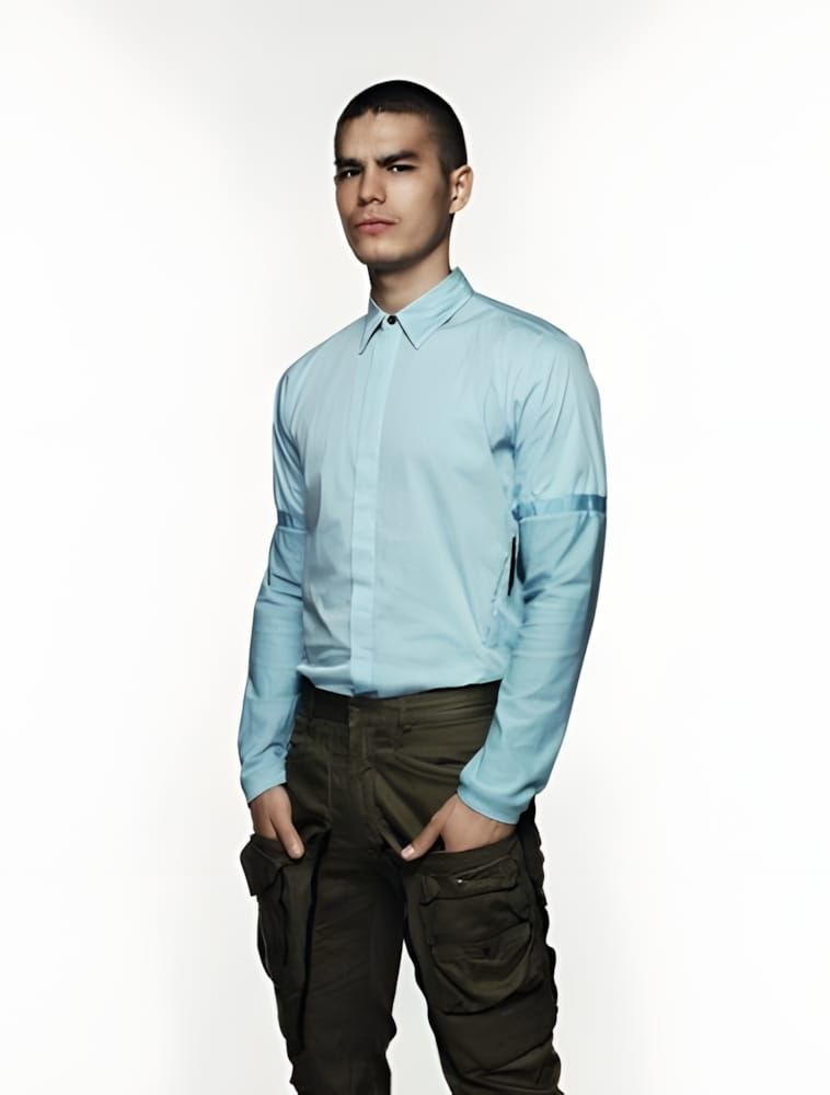 Male model in a pale sky-blue technical button-collar shirt with a zip detail on the upper sleeve and dark olive cargo trouse