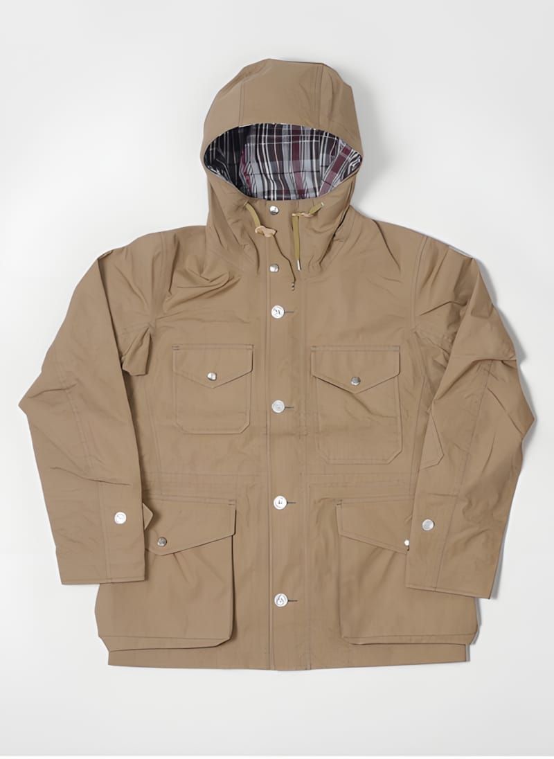 Battenwear Travel Shell Parka in khaki, flat-lay view showing four-pocket layout — two chest patch pockets with snap flaps an