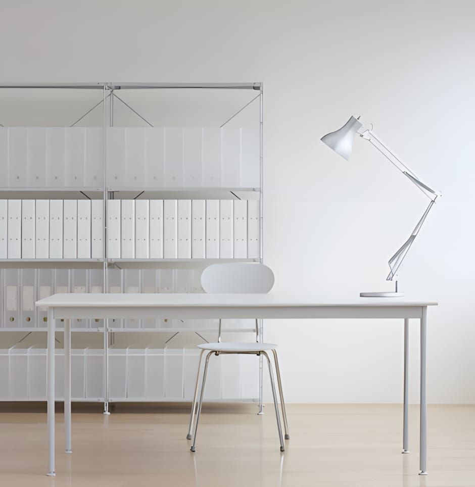 Minimal all-white office interior with Made Design PP polypropylene modular bookcase system — thin metal frame, shelves stack