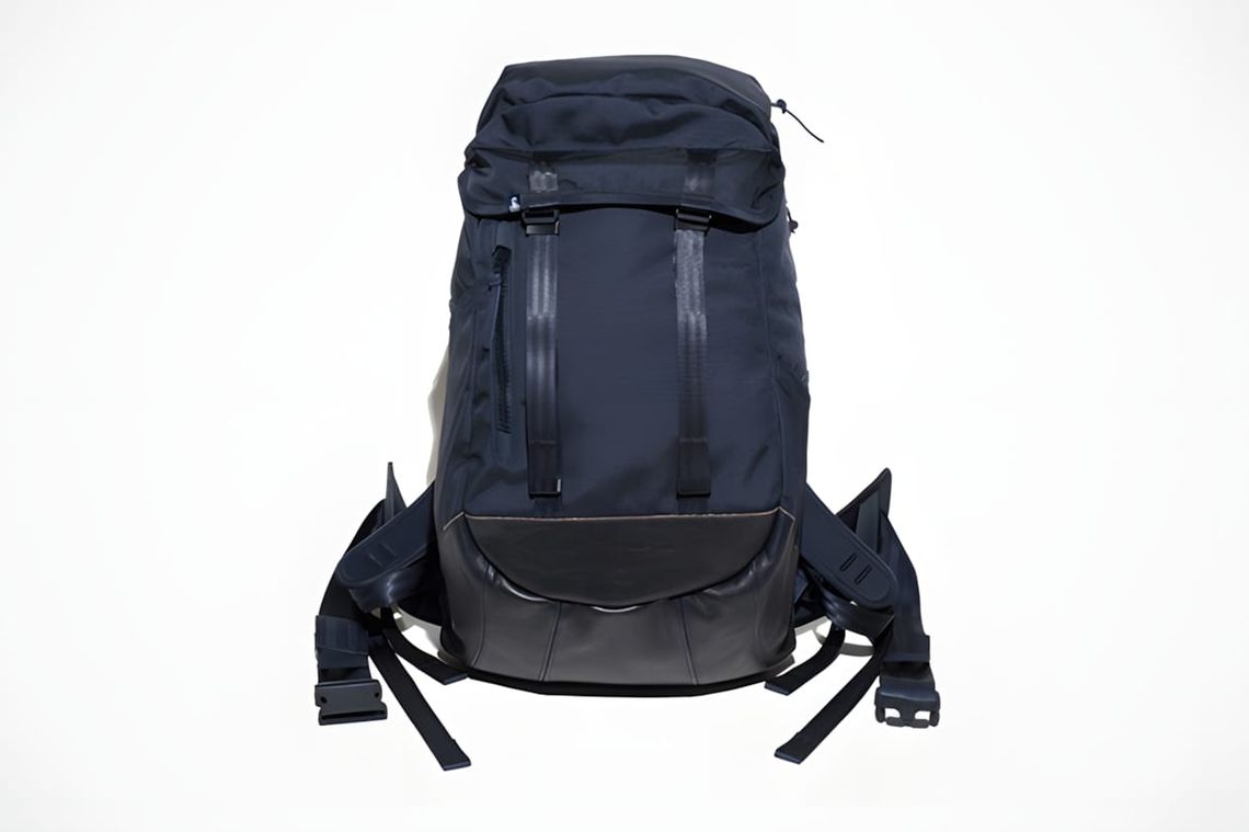 SOPHNET. x visvim Ballistic 23L Backpack in navy — front face-on product shot showing navy Cordura upper, black suede base pa