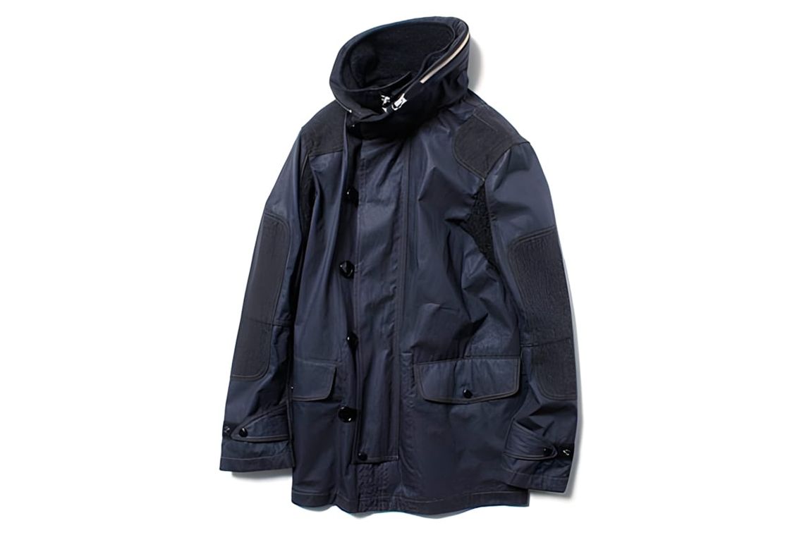 Junya Watanabe Comme des Garçons MAN navy coated hooded jacket flat-lay: rubberized shell body with charcoal wool panels at s