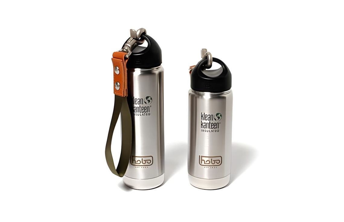 Two Hobo x Klean Kanteen Insulated Classic stainless bottles; larger has olive wrist strap and S-Biner carabiner.