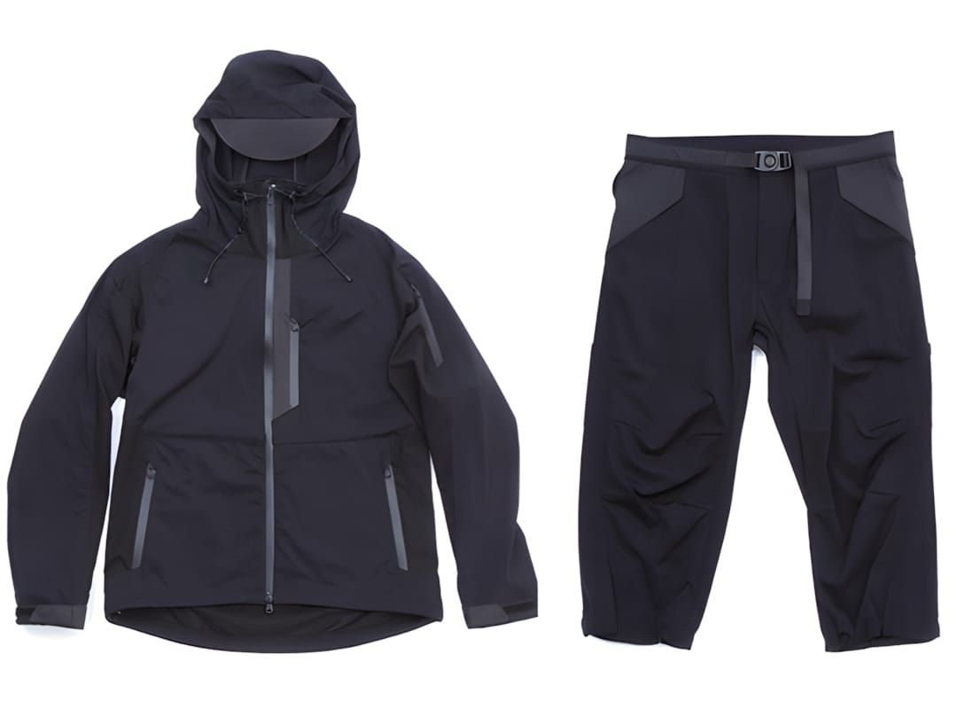 White Mountaineering BLK SS2011 hooded technical jacket and cropped trousers, near-black with graphite contrast panels, ghost