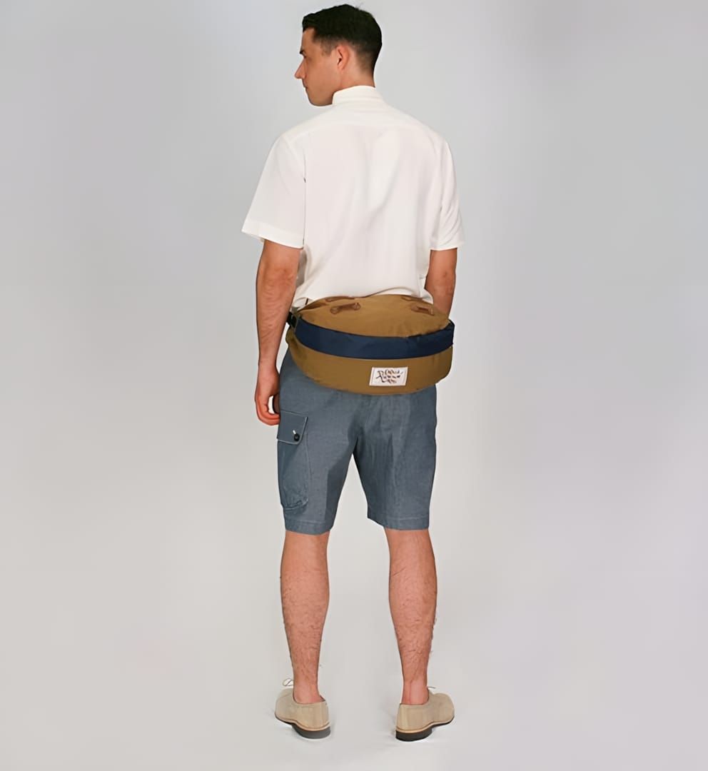 Rear view of Carhartt Legacy Deluxe Tool Belt in brown canvas with navy accent strip, worn at waist.
