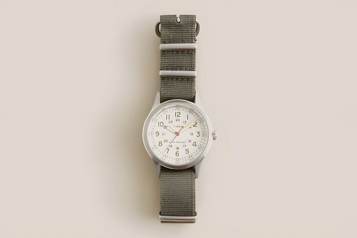 Timex for J.Crew Vintage Field Army Watch with cream dial and olive nylon NATO strap, top-down product shot.