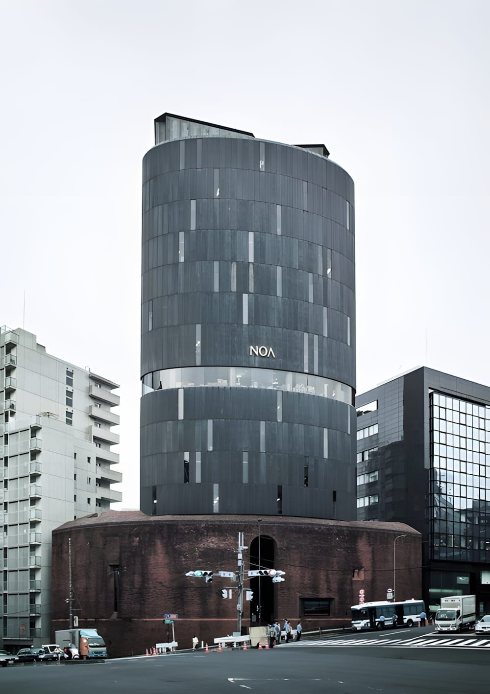 NOA Building in Azabudai, Tokyo — Seiichi Shirai, 1974. Portrait view of the 15-storey tower showing the rusticated red-brick