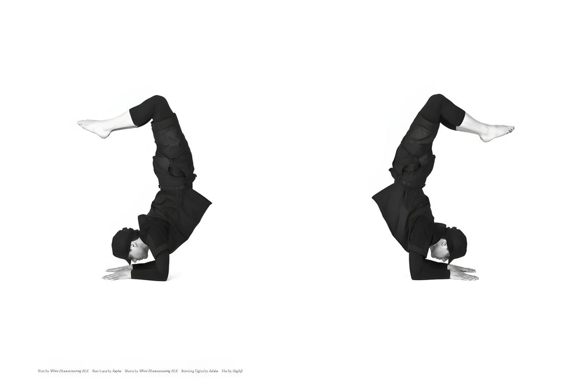Two side-by-side studio shots of a model performing a headstand in all-black technical sportswear — White Mountaineering BLK 