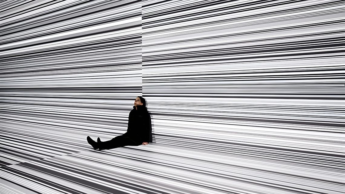 Ryoji Ikeda audiovisual data installation — high-contrast black and white barcode or binary data pattern projection from the 