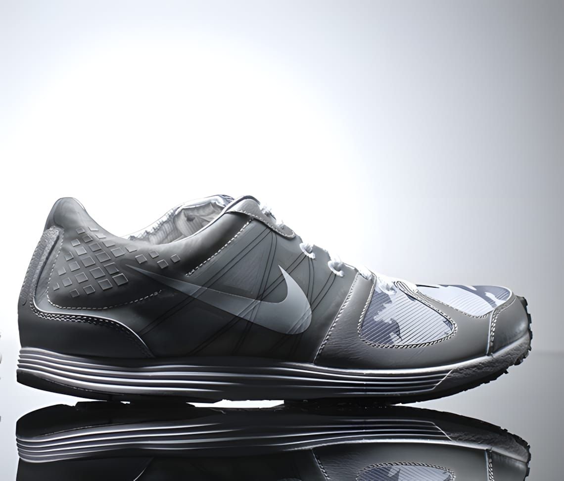 Nike LunarSpider R TZ in grey camouflage, lateral view, with silver Swoosh and black outsole.