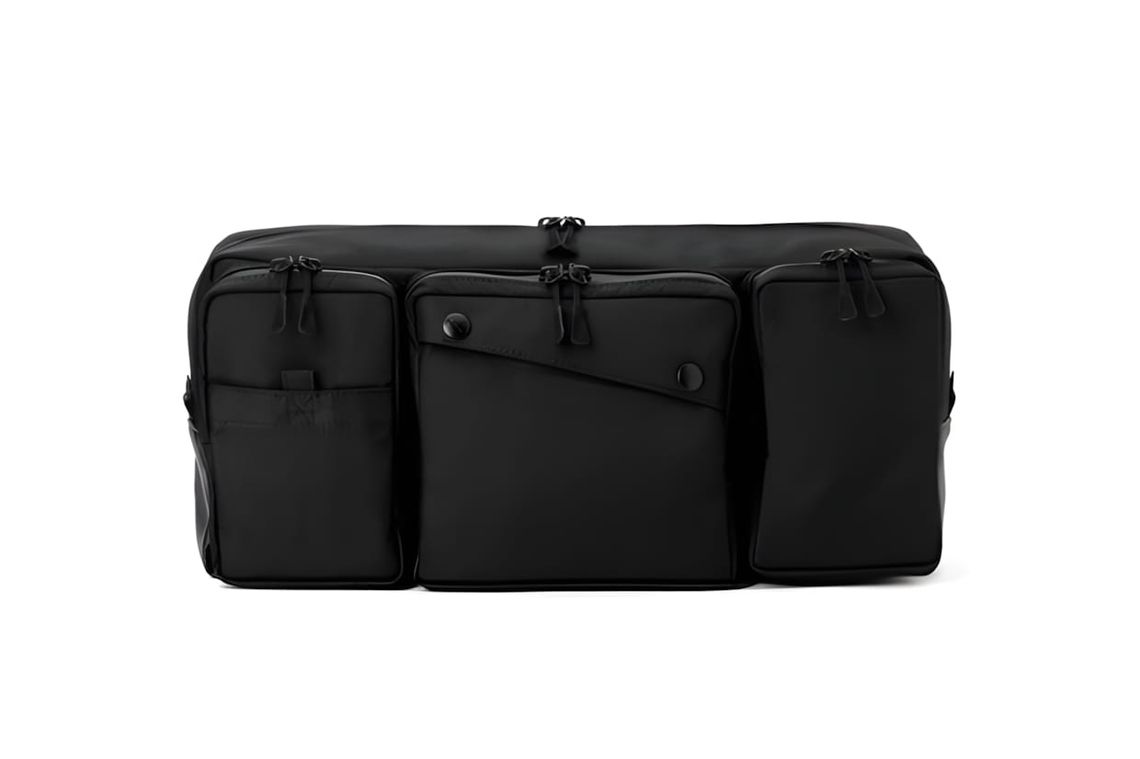 Chrome Industries Segment sling bag in black ballistic nylon, front view showing two snap-closure pockets and zipper pulls ac