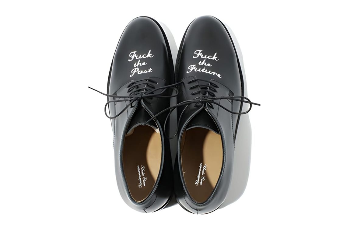 UNDERCOVER FW2012 black leather Oxford shoe with "Fuck the Past, Fuck the Future" text embossed on the upper