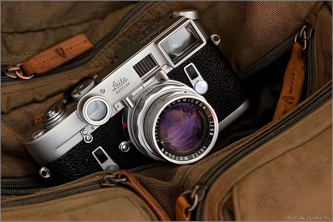 Chrome Leica M4 rangefinder with Summicron 50mm f/2 Dual Range lens in an olive canvas zipper bag.