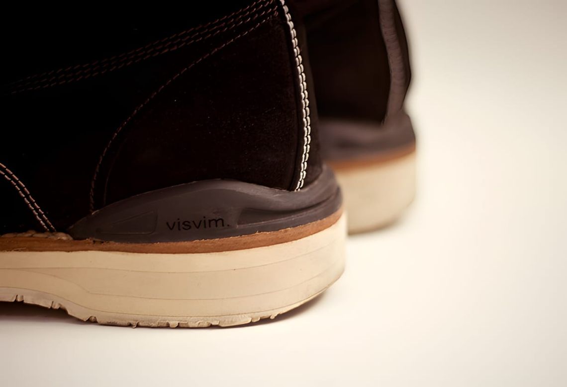 Close-up of visvim Virgil Boots Folk heel and welt in dark brown suede, cream sole, white stitching, visvim stamp visible
