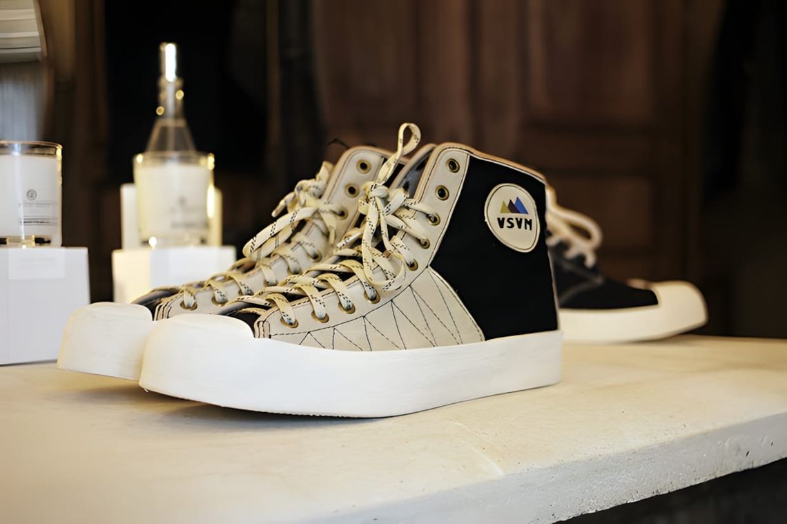 Visvim Sunnegga Hi Lamina boot in suede, showing high-cut silhouette with contrast zig-zag stitching at the toebox and two-to