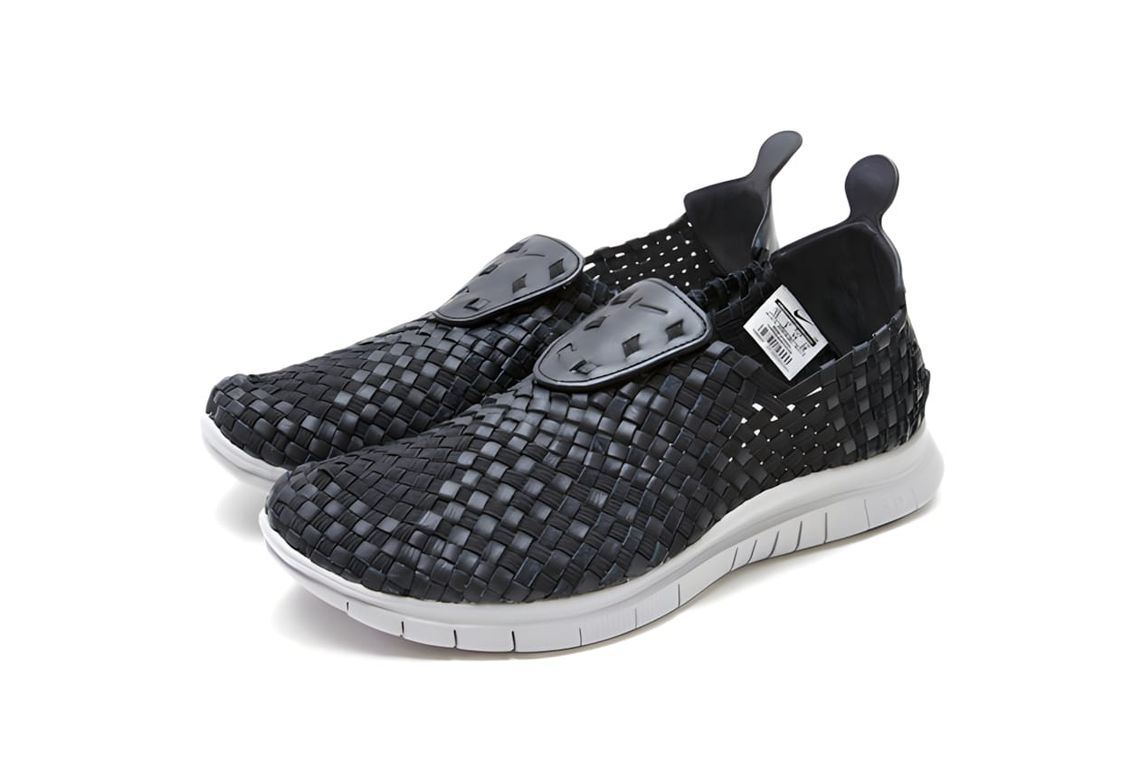Nike Free Inneva Woven slip-on sneakers in black woven nylon upper with white Free 5.0 outsole, three-quarter view.