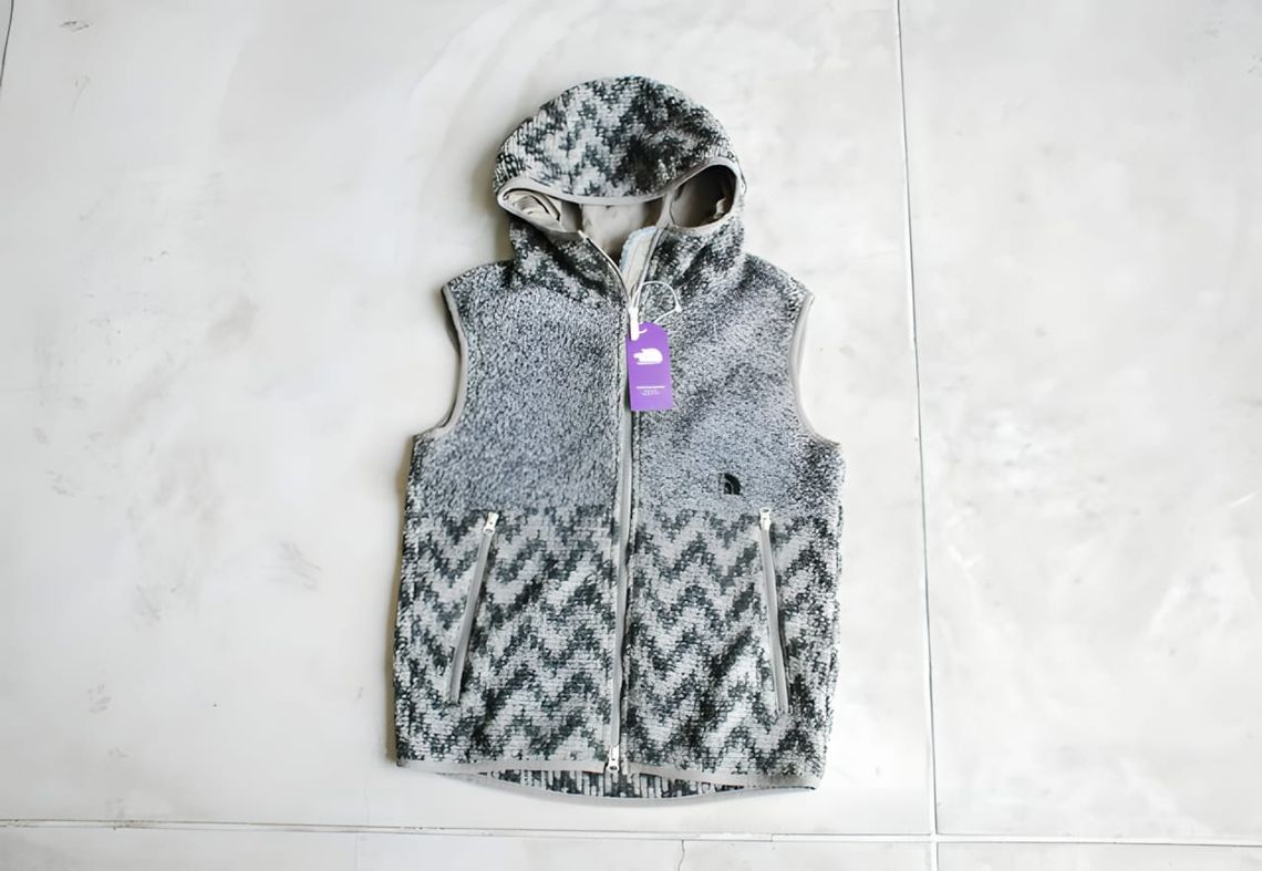 The North Face Purple Label hooded fleece vest, grey and white chevron zigzag jacquard, laid flat with purple hang tag visibl